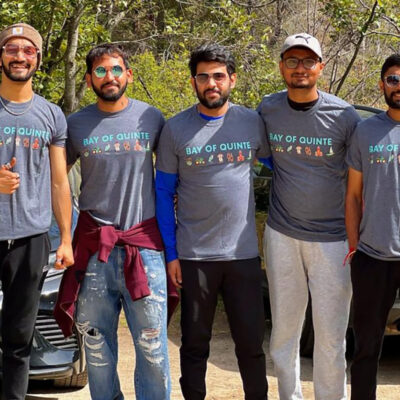 A group of people standing in a row wearing Bay of Quinte t-shirts.