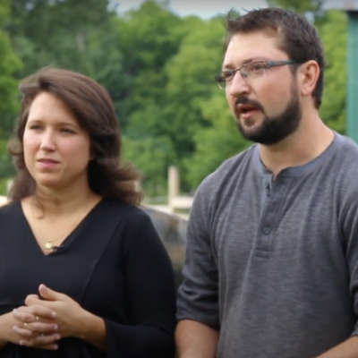 A photo of two people about to speak and looking into the camera.